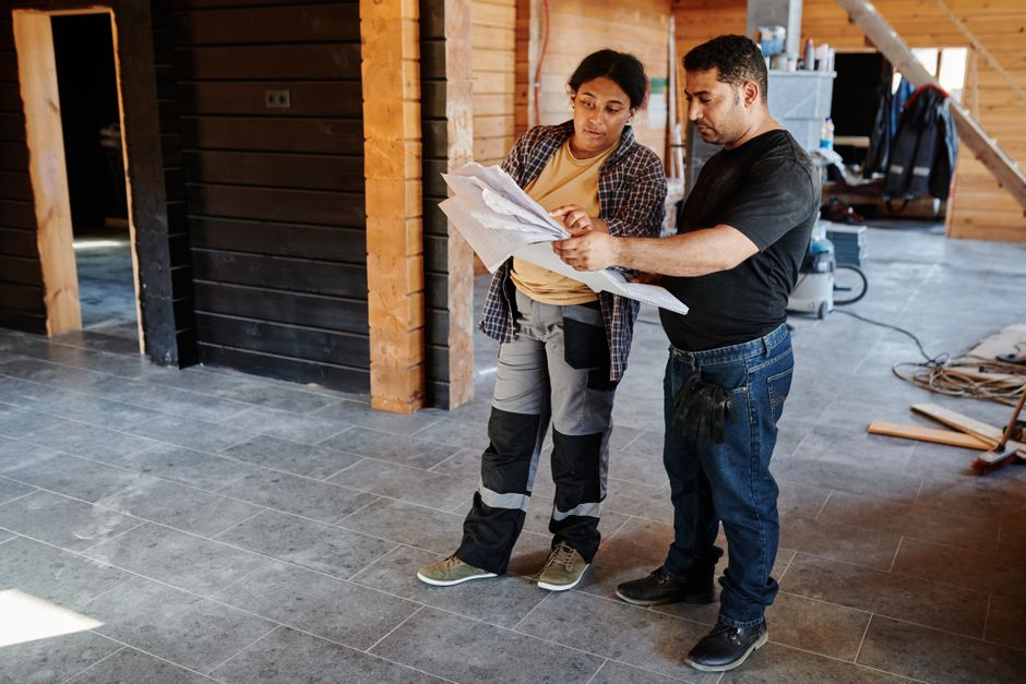 Contractor reviewing blueprints for a custom kitchen renovation
